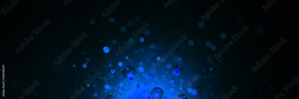 Dark black and blue banner background with bubbles and drops. Magic and mysterious