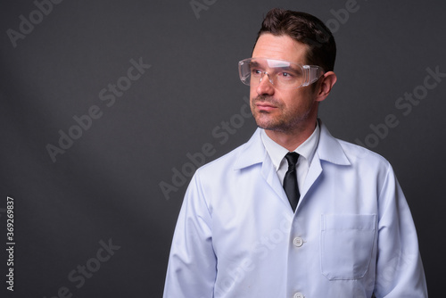 Portrait of handsome bearded man doctor as scientist