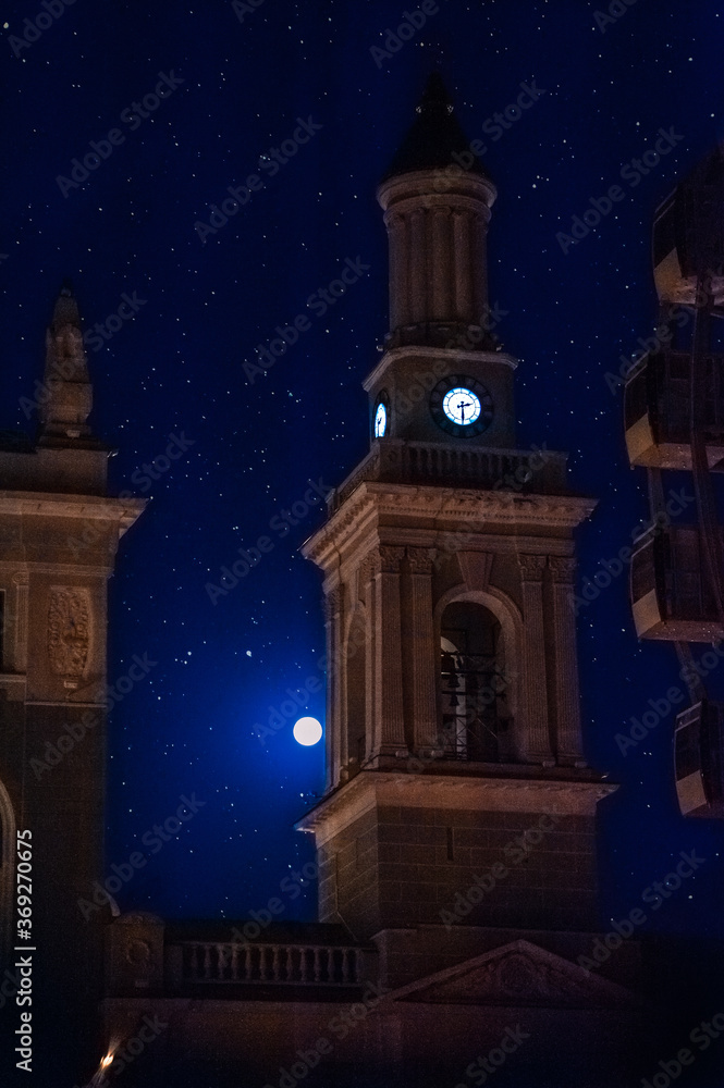 The bell tower of the Church of St. Catherine (Greek Monastery) at night in the light of the moon and stars. Contract Square, Kyiv Ukraine