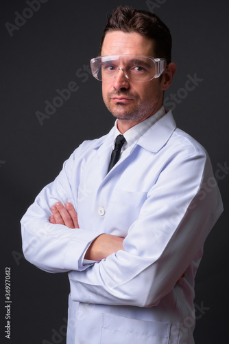 Portrait of handsome bearded man doctor as scientist