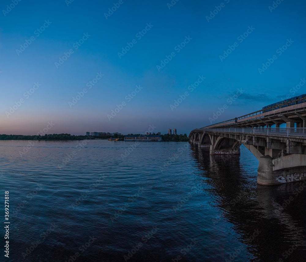 View of the metro bridge and the Dnipro river at sunset. Kiev, Ukraine