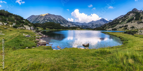 Magnificent summer view with a lake and mountain peak behind, Todorka peak and Muratovo lake in Pirin mountains, Bulgaria