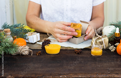 Woman hands wrap handmade soap Preparing presents for Christmas Space for text