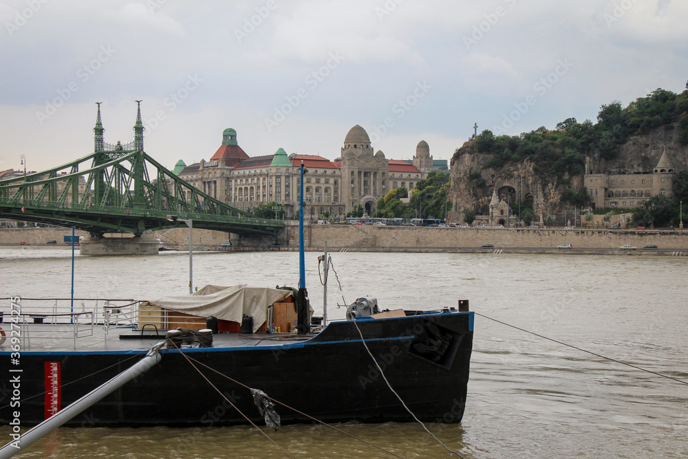 A view across the Danube to Liberty Bridge, Gellert Spa and Cave in Budapest A view across the Danube to Liberty Bridge, Gellert Spa and Cave in Budapest
