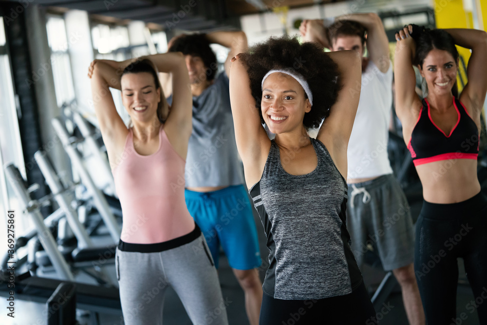 Diversity group of people training in a gym. Trainer and sportive persons exercising Diversity group of people training in a gym. Trainer and sportive persons exercising