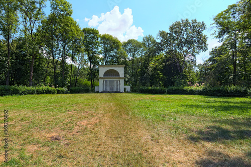 Scenic wide-angle landscape view of grassplot with ancient Rotunda building. It is one of the famous buildings in the Arboretum Oleksandriya in Bila Tserkva, Ukraine. Romantic and peaceful scene photo