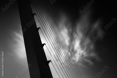 Close up of a modern suspension bridge construction, black and white, long exposure photo