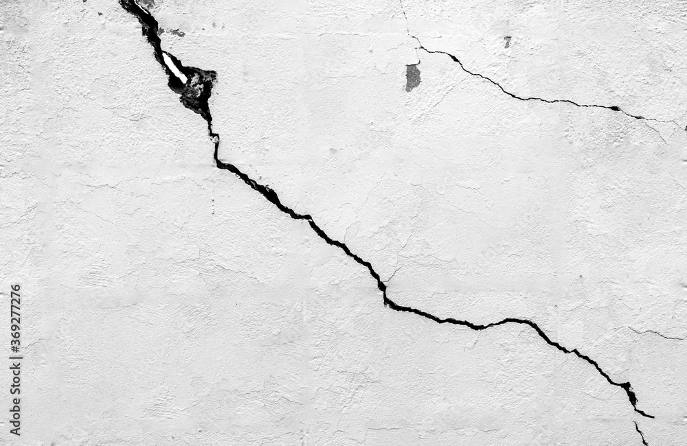 The black and white concept of a plain white plastered brick wall with cracks for backgrounds, patterns and textures for backgrounds. Concrete surfaces are slightly rough. Random seamless wall pattern The black and white concept of a plain white plastered brick wall with cracks for backgrounds, patterns and textures for backgrounds. Concrete surfaces are slightly rough. Random seamless wall pattern