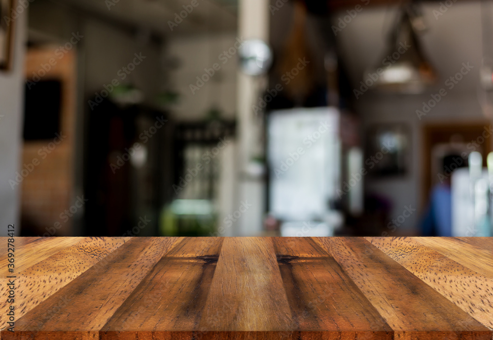 Empty wooden table top with lights bokeh on blur restaurant background Empty wooden table top with lights bokeh on blur restaurant background