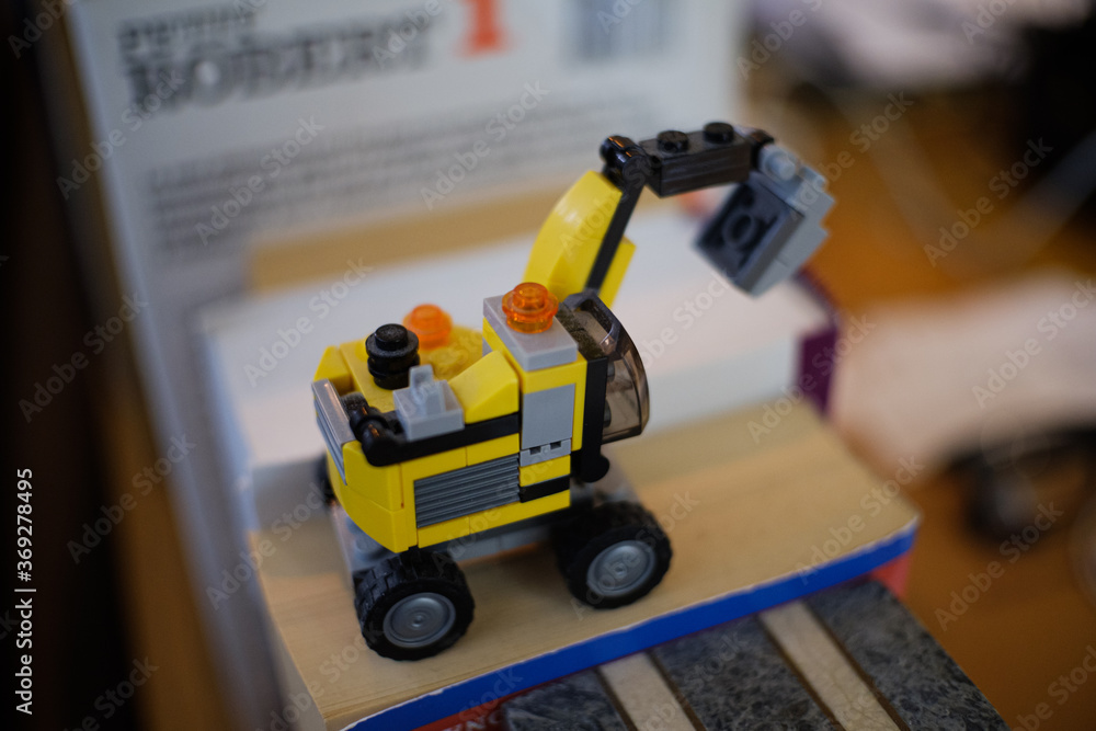 Obraz premium Toy truck on bookshelf