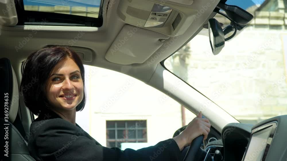 Elegant beautiful businesswoman sitting in car salon Elegant beautiful businesswoman sitting in car salon