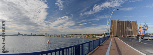 The Limfjord bridge opens for ship traffic from driver perspective.  Limfjordsbroen bridge which connects Nørresundby and Aalborg over Limfjord, a shallow sound.  Bascule bridge across the Langerak. photo