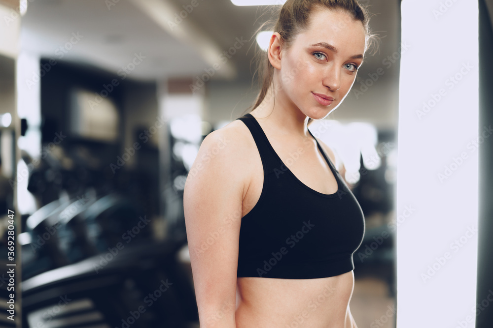 Portrait of a young sporty caucasian woman training in a fitness club Portrait of a young sporty caucasian woman training in a fitness club