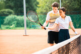 Young couple playing tennis at the court