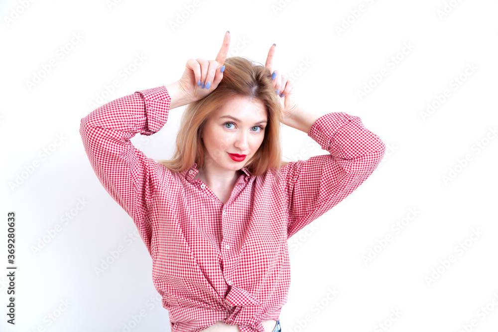 Young beautiful woman showing horns on white background Young beautiful woman showing horns on white background