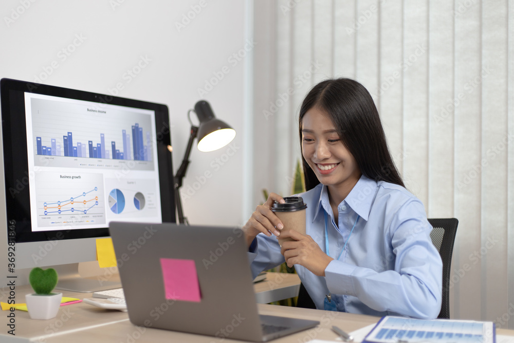 Asian woman sips coffee and works in a private room. Asian woman sips coffee and works in a private room.