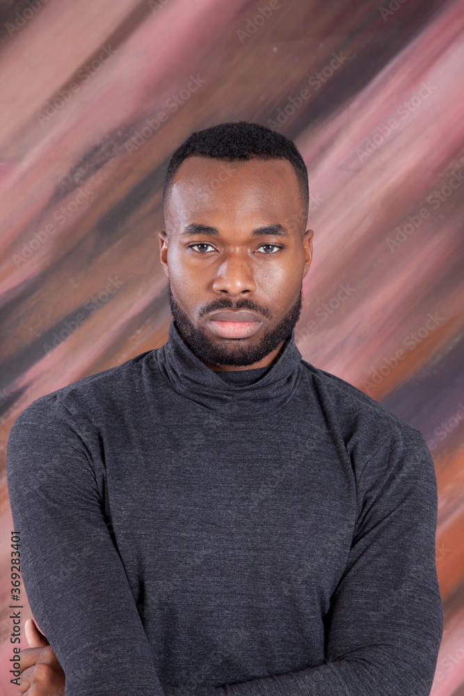 Handsome Black man looking Pensive in a grey shirt Handsome Black man looking Pensive in a grey shirt