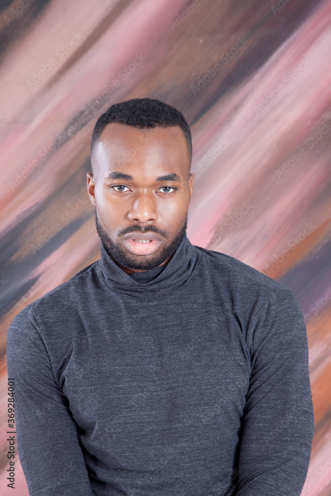 Handsome Black man looking Pensive in a grey shirt Handsome Black man looking Pensive in a grey shirt