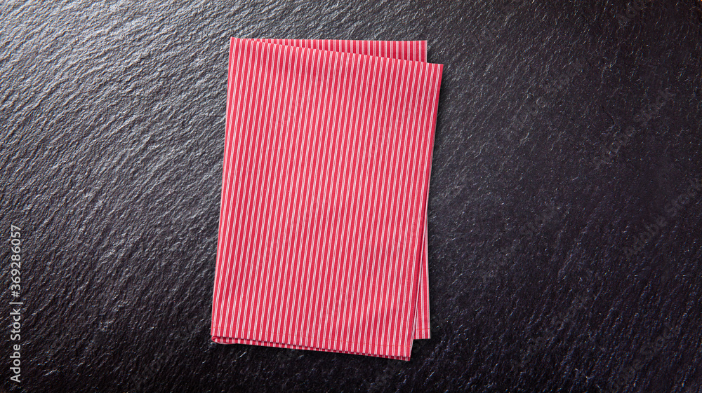 Red table cloth. Stack of colorful dish towels on desk Red table cloth. Stack of colorful dish towels on desk