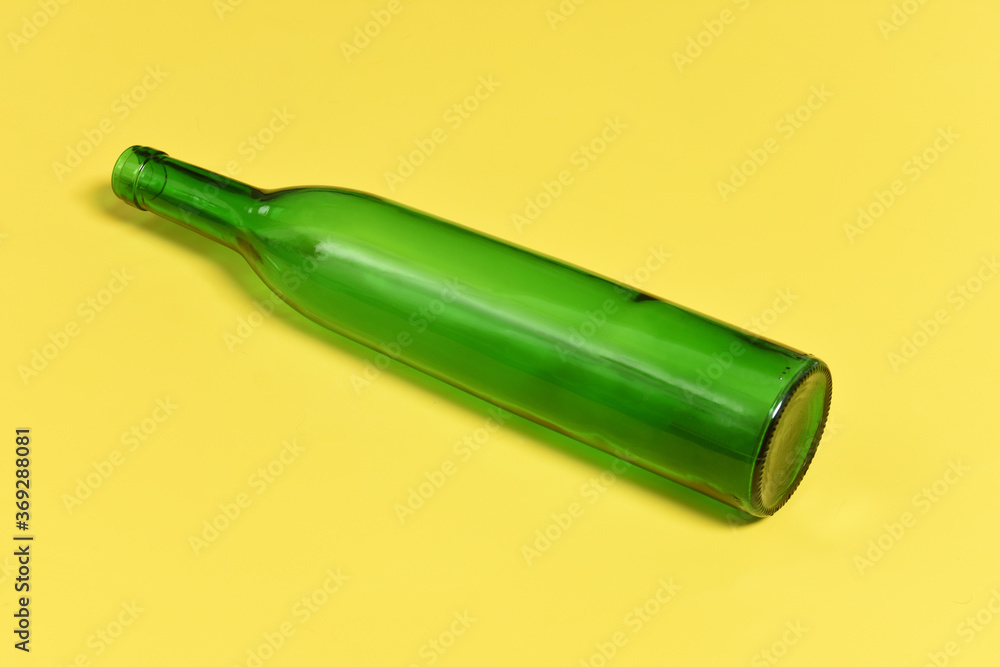 green glass bottle on a yellow background green glass bottle on a yellow background