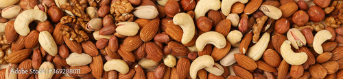 Different nuts on beige background, top view. Vitamin food