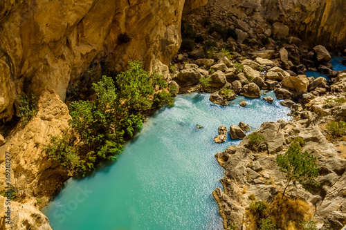 A view looking down on the Gaitanejo river as it flows through the gorge from the Caminito del Rey pathway near Ardales, Spain in the summertime