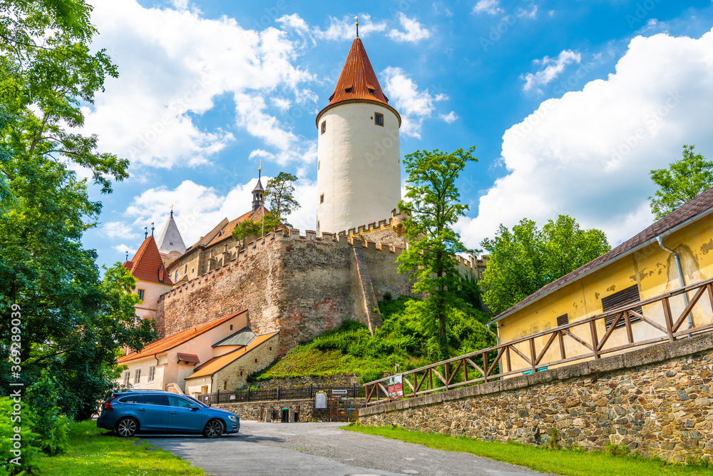 The Krivoklat castle, Czech republic. Famous gothic castle built on big rock. Summer day with blue sky and clouds. Famous tourist destination, medieval architecture.