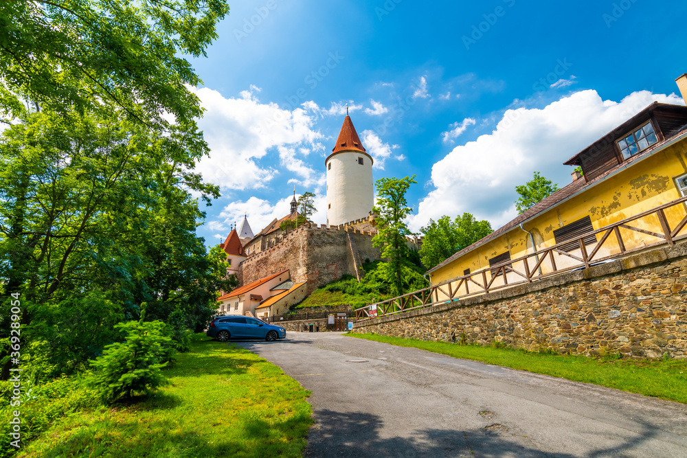 The Krivoklat castle, Czech republic. Famous gothic castle built on big rock. Summer day with blue sky and clouds. Famous tourist destination, medieval architecture.