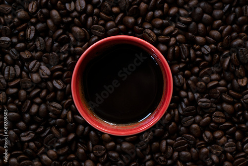 close up of coffee beans and a coffee cup  hot drink beverage concept