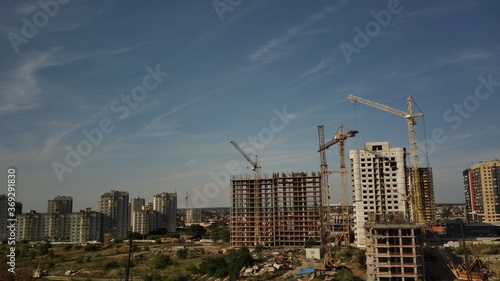 Modern building under construction with crane. Constructing building with high crane