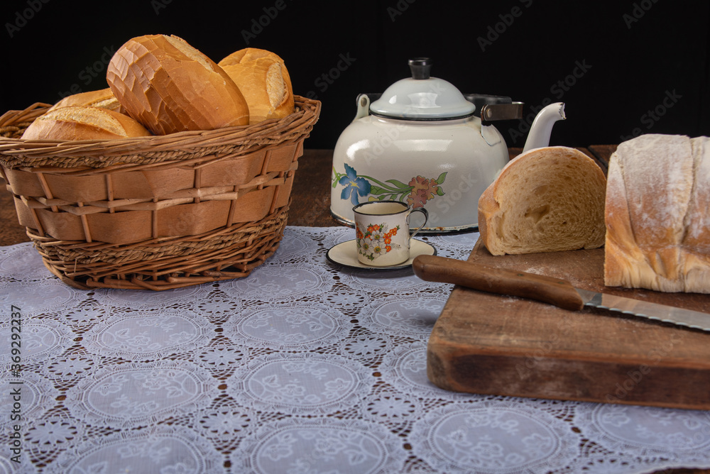 Breakfast table with breads and accessories on rustic wood, selective focus