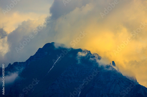 Beautiful landscape with cliff mountain seen through morning fog.