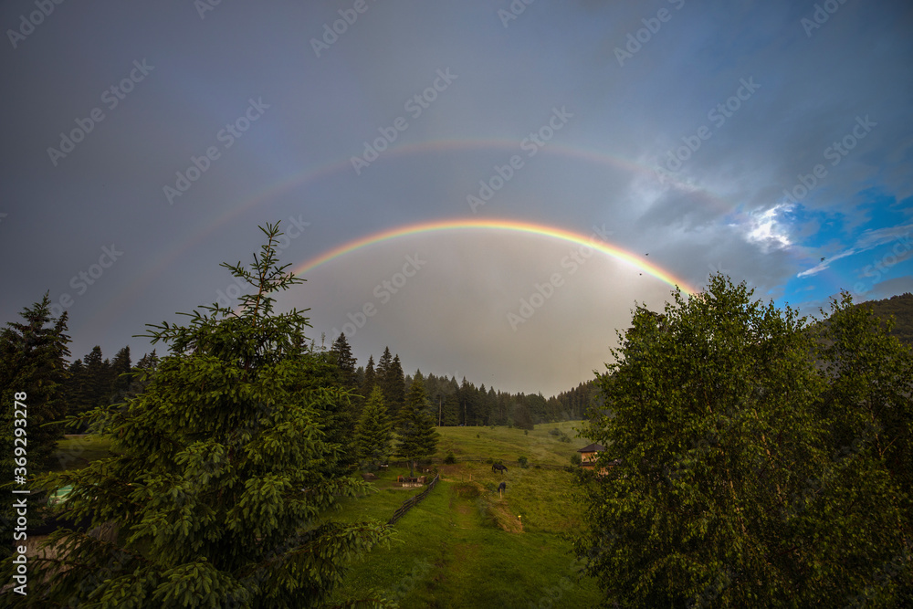 A beautiful rainbow in the mountain landscape. A beautiful rainbow in the mountain landscape.
