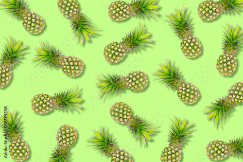 The texture colorful fruit pattern of pineapple fruit on green background, flat lay