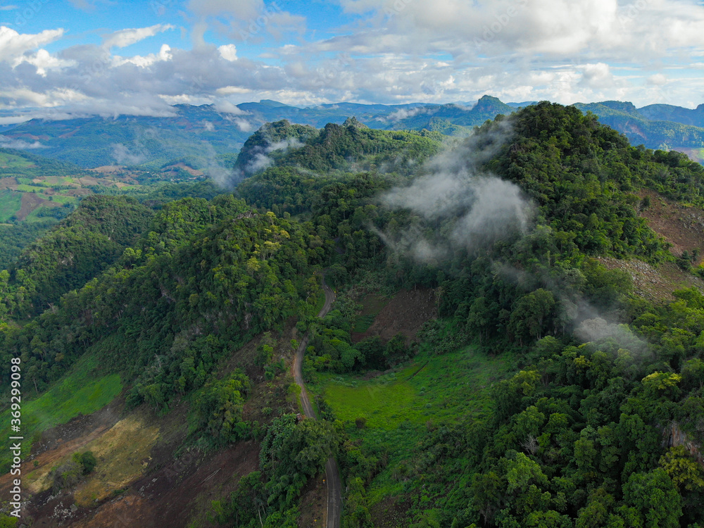 Aerial view shot taken from a drone, Beautiful mist over the mountain on evening time sunset and fog at Ban Ja Bo village, Mae Hong Son province. Aerial view shot taken from a drone, Beautiful mist over the mountain on evening time sunset and fog at Ban Ja Bo village, Mae Hong Son province.