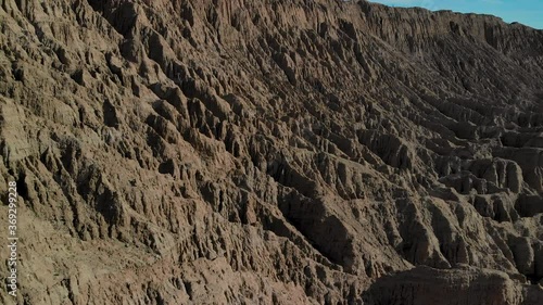 Cinematic aerial flyover of badlands at Font's Point in Anza Borrego Desert State Park in Southern California photo