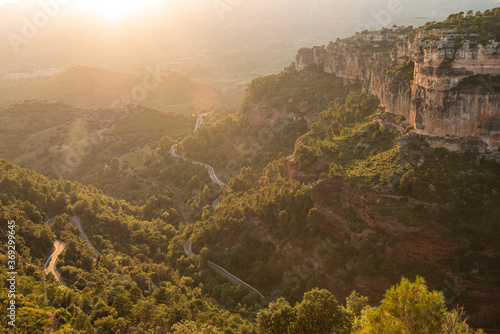 Photography A windy road leads up forest mountainside up the Catalan town of Siurana