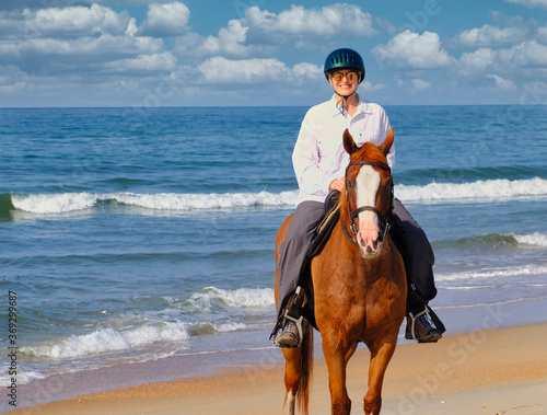 A senior active woman self-caring by exercising and horseback riding. 