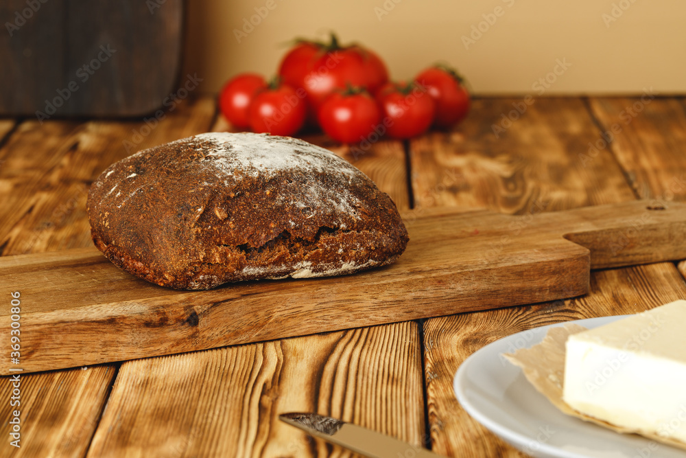 Rye bread on cutting board on wooden table Rye bread on cutting board on wooden table