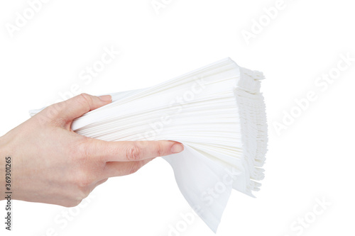 Paper napkins in female hand on white background