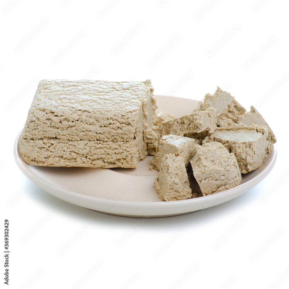 Sunflower halva on plate on white background isolation Sunflower halva on plate on white background isolation