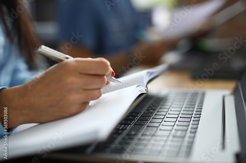 Quadro su tela Female hand holds pen with notebook