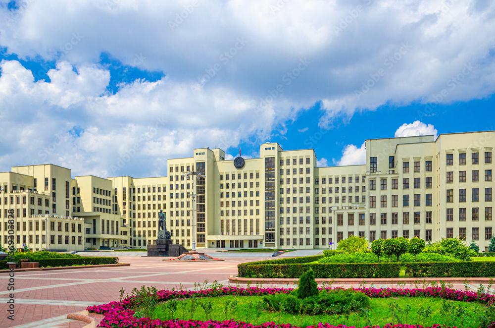 The Government House constructivism style building and Vladimir Lenin statue on Independence Square in Minsk city historical centre, blue sky white clouds in sunny summer day, Republic of Belarus