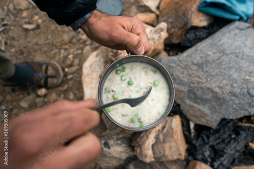 man holding camping soup photo