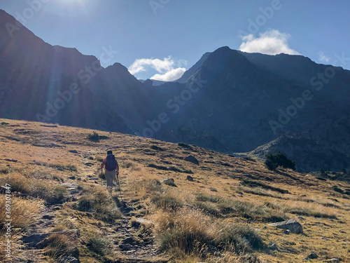 hiker woman walking towards the summit of the Canigou at dawn photo