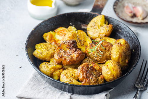 Homemade baked smashed baby potatoes with garlic, salt and herbs