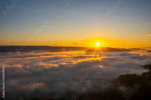 Beautiful landscape in the mountains at sunrise with mist and fog sunrays at mekong River Thai-Laos border Nong Khai province,Thailand. (selective focus and white balance shifting applied)
