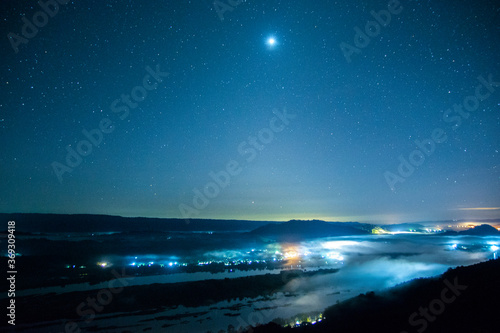 Night scape with beautiful stary sky and city light mountain background at mekong River Thai-Laos border Nong Khai province,Thailand. (selective focus and white balance shifting applied) © serra715