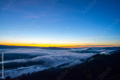 Beautiful landscape in the mountains at sunrise with mist and fog at mekong River Thai-Laos border Nong Khai province,Thailand. (selective focus and white balance shifting applied)