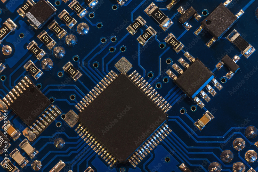 Close-up of a blue printed circuit board (PCB) with stripes of conductors between a transistor and an electronic equipment processor. IT technologies in programming, upgrade and abstract background Stock 사진 | Adobe Close-up of a blue printed circuit board (PCB) with stripes of conductors between a transistor and an electronic equipment processor. IT technologies in programming, upgrade and abstract background Stock 사진 | Adobe